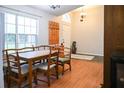 Bright dining area with a wooden table set, coat rack, and natural light at 1430 Arrowhead Trl, Deltona, FL 32725