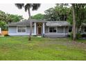 Inviting single-story home featuring a covered front porch and a neatly kept lawn at 1430 Arrowhead Trl, Deltona, FL 32725