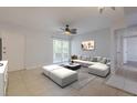 Inviting living room includes stylish seating, outdoor access, and tile flooring at 151 N Orlando Ave # 204, Winter Park, FL 32789