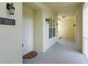 Well-lit hallway featuring unit number, sconce lighting, and access to a stairwell with a neutral color palette and clean finishes at 1630 Common Way Rd # 203, Orlando, FL 32814