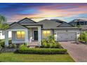 Charming single-story home showcasing a brick driveway, well-maintained landscaping, and a welcoming entrance at 17333 Hickory Wind Dr, Clermont, FL 34711