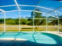 Relaxing screened-in pool area, great for outdoor fun with beautiful backyard views and ample space for lounging at 17517 Silver Creek Ct, Clermont, FL 34714