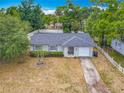 An elevated view shows a well-kept home with a manicured lawn and white picket fence at 181 Ada Ave, Orange City, FL 32763