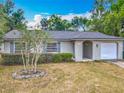 Charming single-story home featuring a well-maintained lawn and attached one-car garage at 181 Ada Ave, Orange City, FL 32763