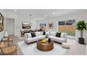 Bright, neutrally-toned open-concept living room and dining area with sleek flooring and modern furniture at 1816 Haperon St, Apopka, FL 32703