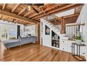 Inviting living room with exposed wood beams, wood floors, and staircase at 1901 10Th St, St Cloud, FL 34769