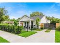 Beautifully landscaped home featuring a modern fence and an extended driveway for easy access at 2110 Hillcrest St, Orlando, FL 32803