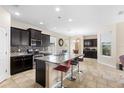Modern kitchen with dark cabinets, granite countertops, and stainless steel appliances at 2136 J Lawson Blvd, Orlando, FL 32824