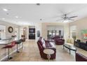 Spacious living room with tile floors, comfortable leather seating, and ample natural light at 2136 J Lawson Blvd, Orlando, FL 32824