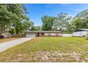 Charming single-story home with a well-manicured front yard and attached garage, perfect for suburban living at 2312 Ne 32Nd Pl, Ocala, FL 34479