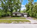 Charming single-story home with gray siding, inviting front porch, and a one-car garage at 2312 Vivada St, Orlando, FL 32803