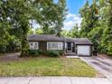 Charming single-story home with gray siding, inviting front porch, and a one-car garage at 2312 Vivada St, Orlando, FL 32803