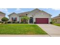 Well-maintained single-Gathering home with lush green lawn and colorful landscaping at 2518 Hayden Valley St, Apopka, FL 32703