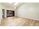 Bright living room with vaulted ceilings, skylights, ceiling fan, and sliding doors to the exterior at 2924 S Semoran Blvd # D2, Orlando, FL 32822