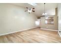 Open-concept living room with vaulted ceilings, fan, and a view into the kitchen at 2924 S Semoran Blvd # D2, Orlando, FL 32822