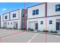 Contemporary townhouse boasts a sleek exterior with clean lines, stone accents, and dedicated parking spaces for convenience at 296 Famagusta Dr, Davenport, FL 33896