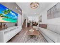 Stylish living room with an open-concept design, modern decor, and a staircase leading to the upper level at 296 Famagusta Dr, Davenport, FL 33896