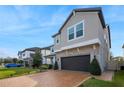 Two-story home with stone accents, a brick driveway, and well-maintained landscaping at 3310 Stonewyck St, Orlando, FL 32824