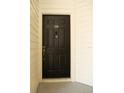 Solid black front door featuring a peephole, door knocker, and the unit number '215' at 413 Summit Ridge Pl # 215, Longwood, FL 32779
