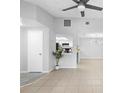 Bright living room boasts tile floors, neutral walls, and a view into the kitchen, creating an open and airy space at 4636 Fern Pine Dr, Orlando, FL 32808