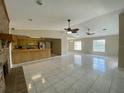 Bright open-concept living room features tile floors, brick fireplace and open kitchen at 5050 Hidden Springs Blvd, Orlando, FL 32819