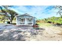 A cozy blue house with a welcoming porch, offering a serene and comfortable living space at 509 Grove Ave, Orlando, FL 32805