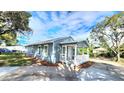 Quaint blue home featuring a welcoming porch, fresh mulch, and curb appeal at 509 Grove Ave, Orlando, FL 32805