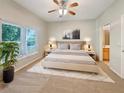 Relaxing main bedroom with a ceiling fan, plush carpet, and serene decor at 5236 Shale Ridge Trl, Orlando, FL 32818