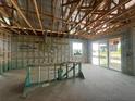 Unfinished living room with exposed beams and a sliding glass door, perfect for customization at 5391 Park Guell St, St Cloud, FL 34771
