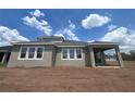 The house's rear showcases large, bright windows and a covered patio, perfect for outdoor relaxation and entertaining at 5391 Park Guell St, St Cloud, FL 34771