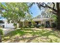 Lovely single-story home with a well-maintained lawn, mature trees, and an attached two-car garage at 6105 Lost Tree Court, Orlando, FL 32808