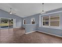 Spacious living room with neutral walls, tile flooring, and ample natural light from the windows at 6702 Imperial Oak Ln, Orlando, FL 32819