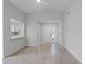 Open-concept living room with wood floors, neutral tones, and view to kitchen and entry at 831 Islander Ave, Orlando, FL 32825