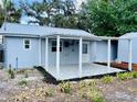 Backyard with a cozy covered patio and newly landscaped garden beds, creating a tranquil outdoor space at 934 Savannah Ave, Lakeland, FL 33815