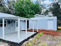 Backyard with a covered patio, providing a perfect setting for outdoor relaxation and entertaining at 934 Savannah Ave, Lakeland, FL 33815