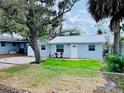 Quaint home with a metal roof, fresh blue paint, and a well-maintained front lawn at 934 Savannah Ave, Lakeland, FL 33815
