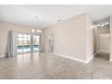 Living room with tiled floor, neutral paint, and sliding glass doors to the pool area at 10 Alicante Ct, Kissimmee, FL 34758
