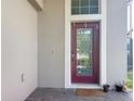 Front door area featuring an elegant glass door, brick flooring and a welcome mat at 10658 Bannan St, Orlando, FL 32832