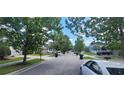 Quiet residential street with lush green trees and well-manicured lawns creating a peaceful neighborhood at 10658 Bannan St, Orlando, FL 32832