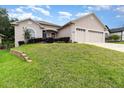 Beautiful home with a well-manicured lawn and two-car garage at 11255 Se 170Th Pl, Summerfield, FL 34491
