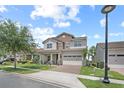 Beautiful home with stone accents, a two-car garage, and a well-maintained lawn on a sunny day at 13139 Stanthorne Ave, Orlando, FL 32832