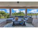 Covered patio with comfortable seating and expansive views of the water at 13139 Stanthorne Ave, Orlando, FL 32832