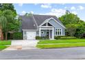 Attractive home features a landscaped front yard, an attached garage, and a well-manicured lawn at 1330 W Harvard St, Orlando, FL 32804