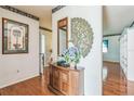 Elegant foyer featuring hardwood floors, decorative wallpaper, and unique wall decorations at 1354 S Shore Dr, St Cloud, FL 34771