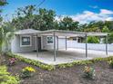Charming single-story home boasts a covered parking area and colorful, meticulously landscaped front yard at 1414 Beaver Pl, Orlando, FL 32806