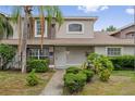 Inviting townhouse entrance with neat landscaping, a well-lit porch and a clean walkway at 14820 Laguna Beach Cir, Orlando, FL 32824