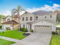 Inviting two-story home with lush landscaping and a convenient two-car garage at 1513 Blue Sky Way, Clermont, FL 34714