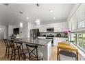 Bright kitchen featuring a granite island, stainless steel appliances, and pendant lighting at 16162 Arbor Crest Aly, Winter Garden, FL 34787