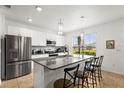 Well-lit kitchen with stainless steel appliances, granite countertops, and a kitchen island at 16162 Arbor Crest Aly, Winter Garden, FL 34787