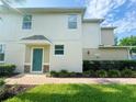 Welcoming front entrance with a teal door, stone accents, and neat landscaping, offering great curb appeal at 1625 Priory Cir, Winter Garden, FL 34787